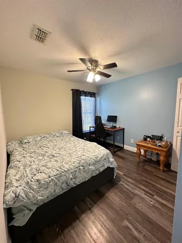 a bedroom with bed and a chandelier