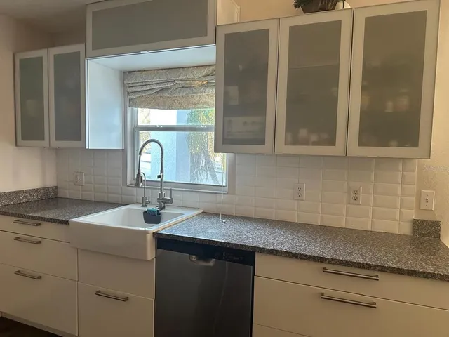 a kitchen with a sink and cabinets