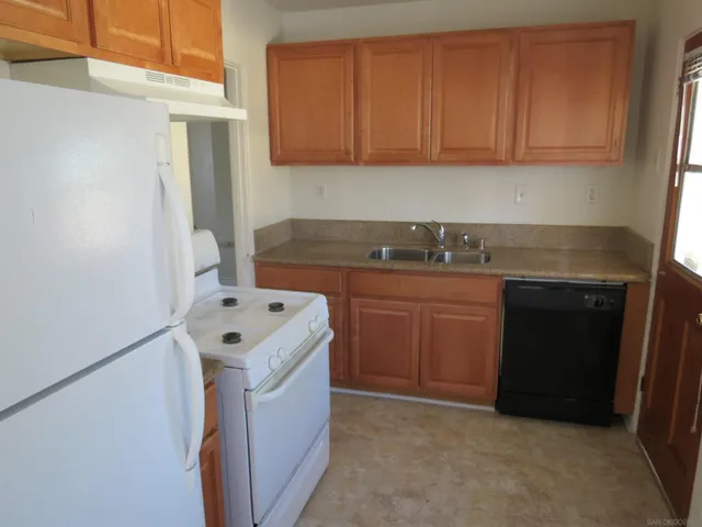 a utility room with sink dryer and washer