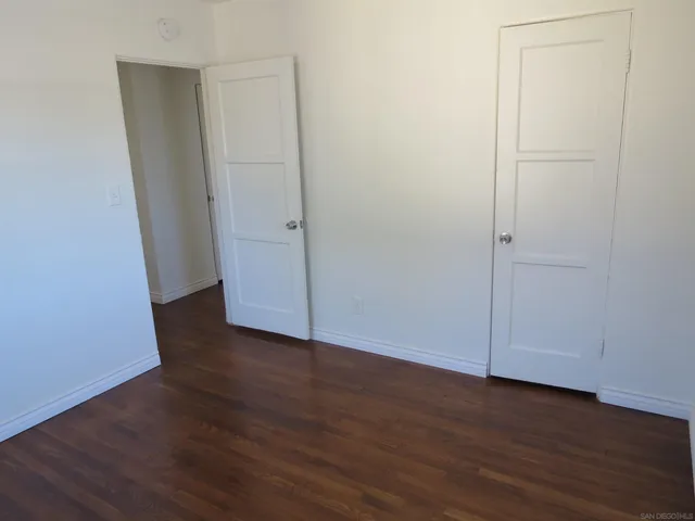 an empty room with wooden floor