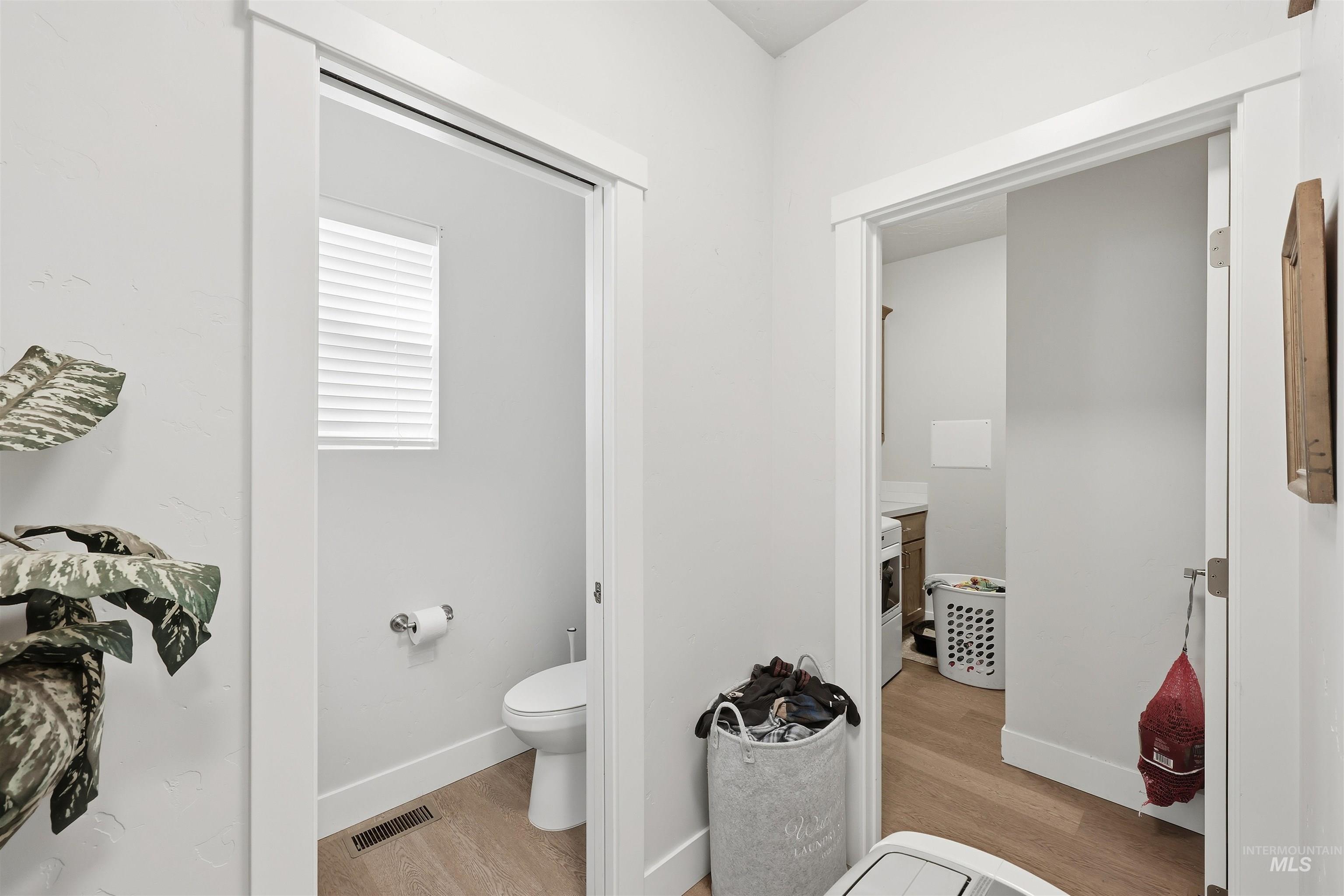 6341 South Ruddsdale Avenue Boise, ID 83709 - Photo 22 of 41 Bathroom with light wood finished floors and toilet