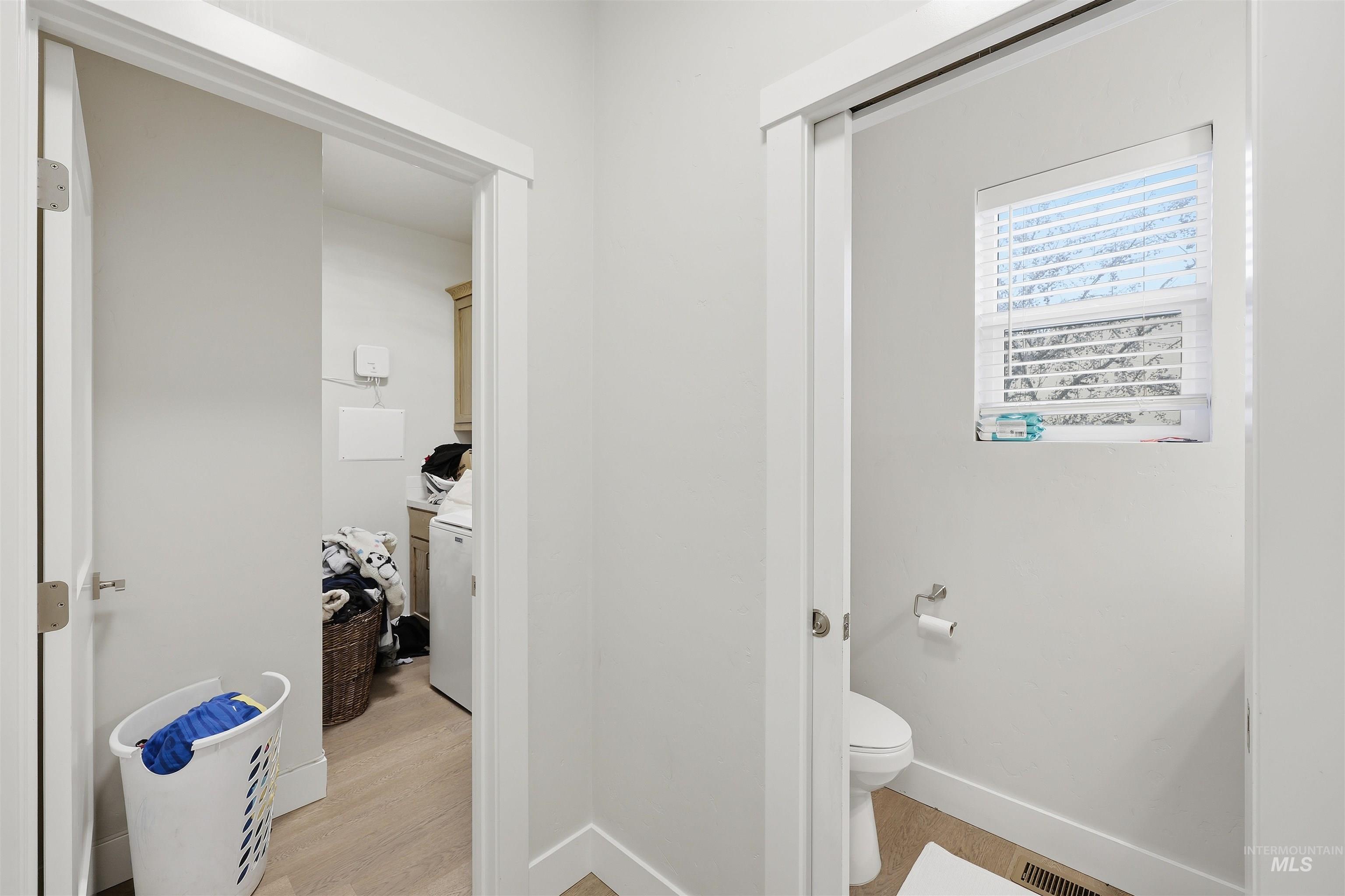 6341 South Ruddsdale Avenue Boise, ID 83709 - Photo 9 of 41 Bathroom featuring toilet and light wood-style flooring