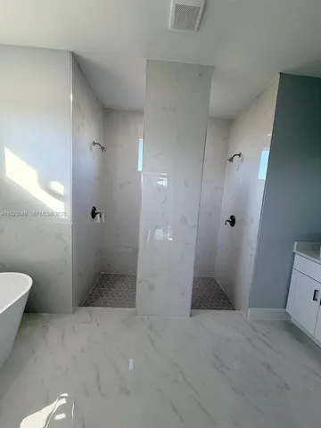 a spacious bathroom with a granite countertop sink a mirror and a