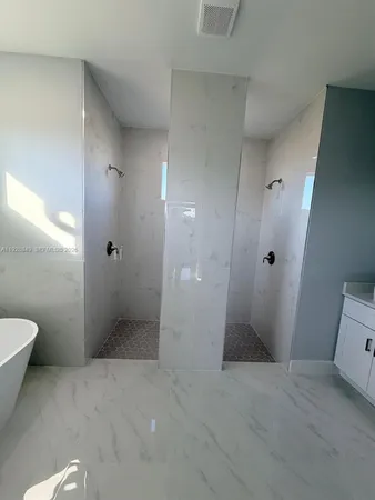 a spacious bathroom with a granite countertop sink a mirror and a