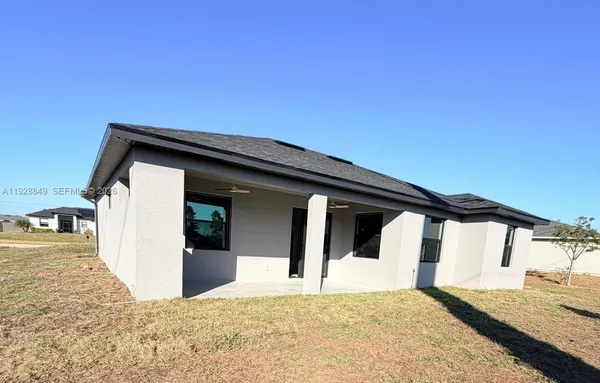 a front view of a house with a empty space and balcony