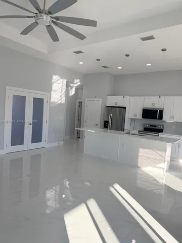 a view of a living room a window and a chandelier