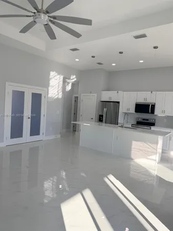 a view of a living room a window and a chandelier