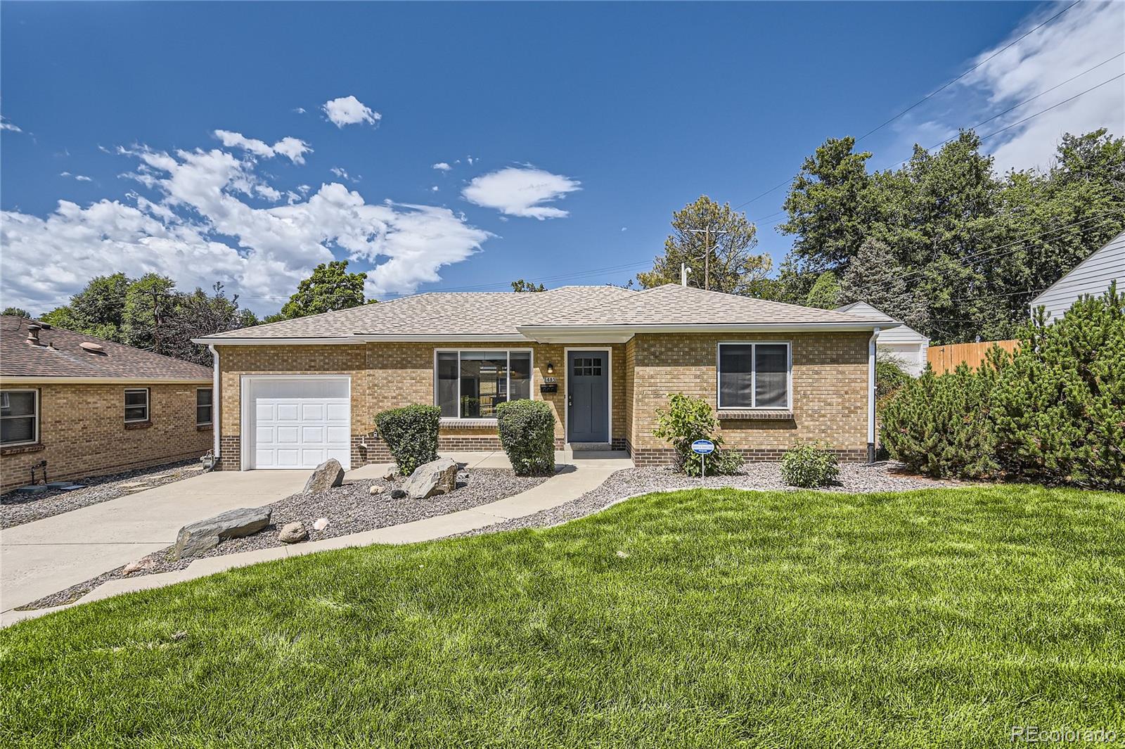 a front view of house with yard and outdoor seating