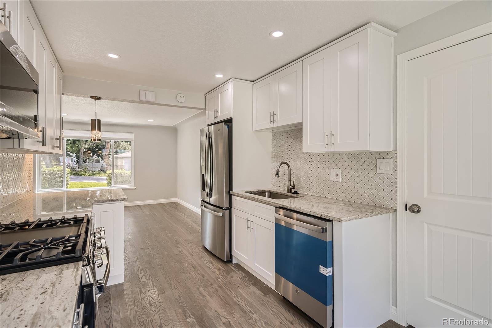 3485 Teller Street Wheat Ridge, CO 80033 - Photo 4 of 9 a kitchen with stainless steel appliances a sink stove and refrigerator