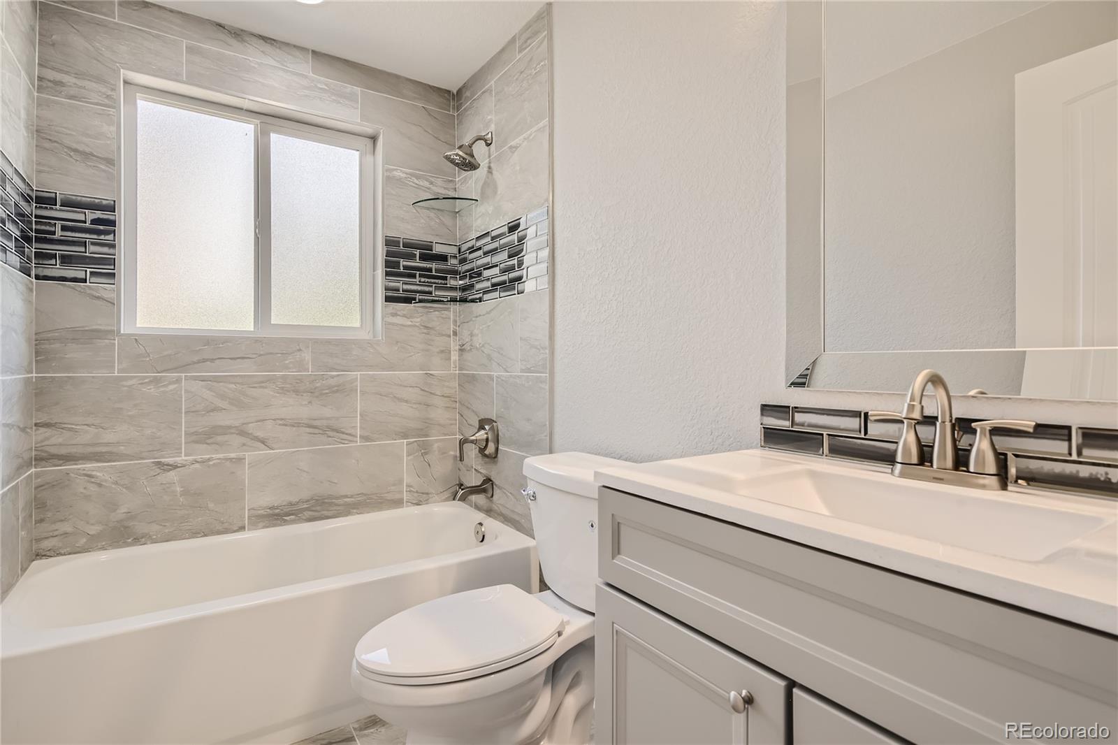 3485 Teller Street Wheat Ridge, CO 80033 - Photo 6 of 9 a bathroom with a sink a toilet and bathtub