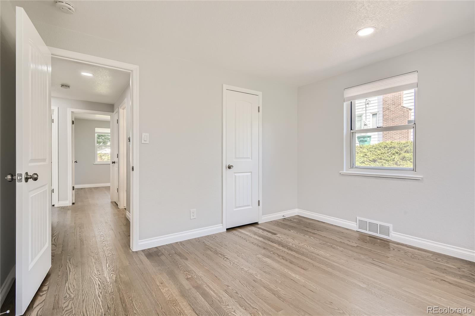 3485 Teller Street Wheat Ridge, CO 80033 - Photo 7 of 9 wooden floor in an empty room with a window