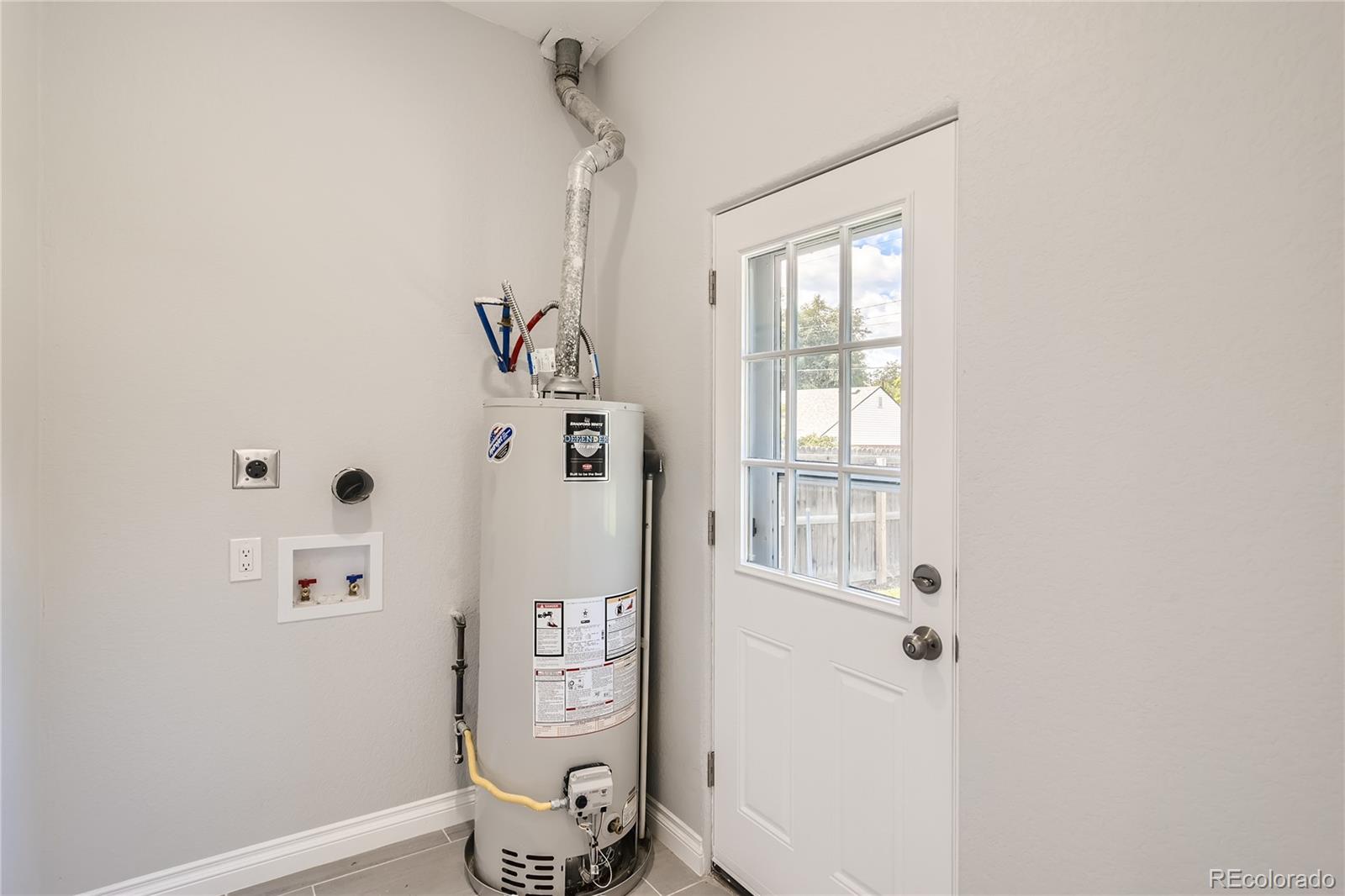 3485 Teller Street Wheat Ridge, CO 80033 - Photo 9 of 9 a bathroom with a shower and a window