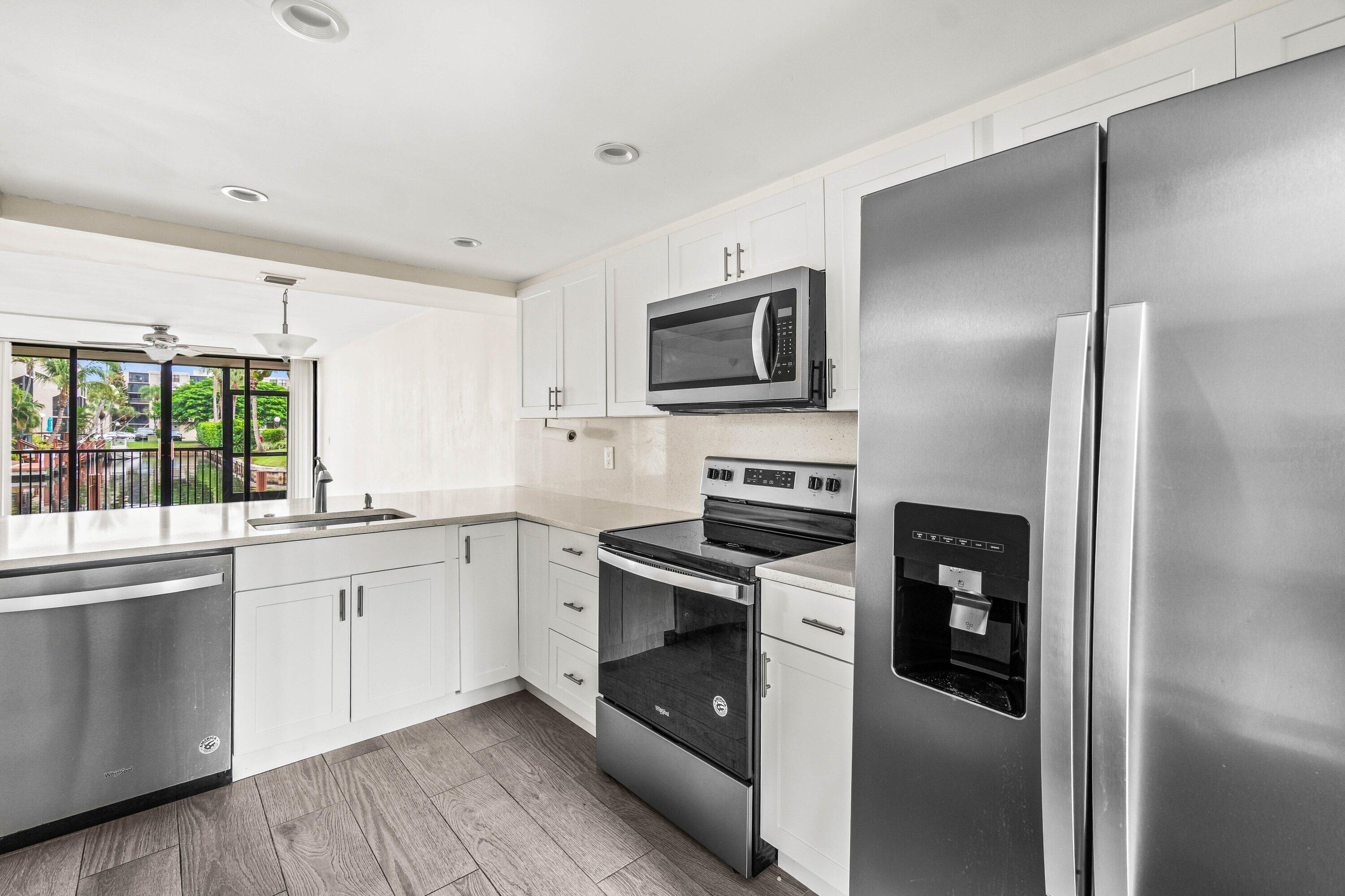 a kitchen with a sink stainless steel appliances and cabinets