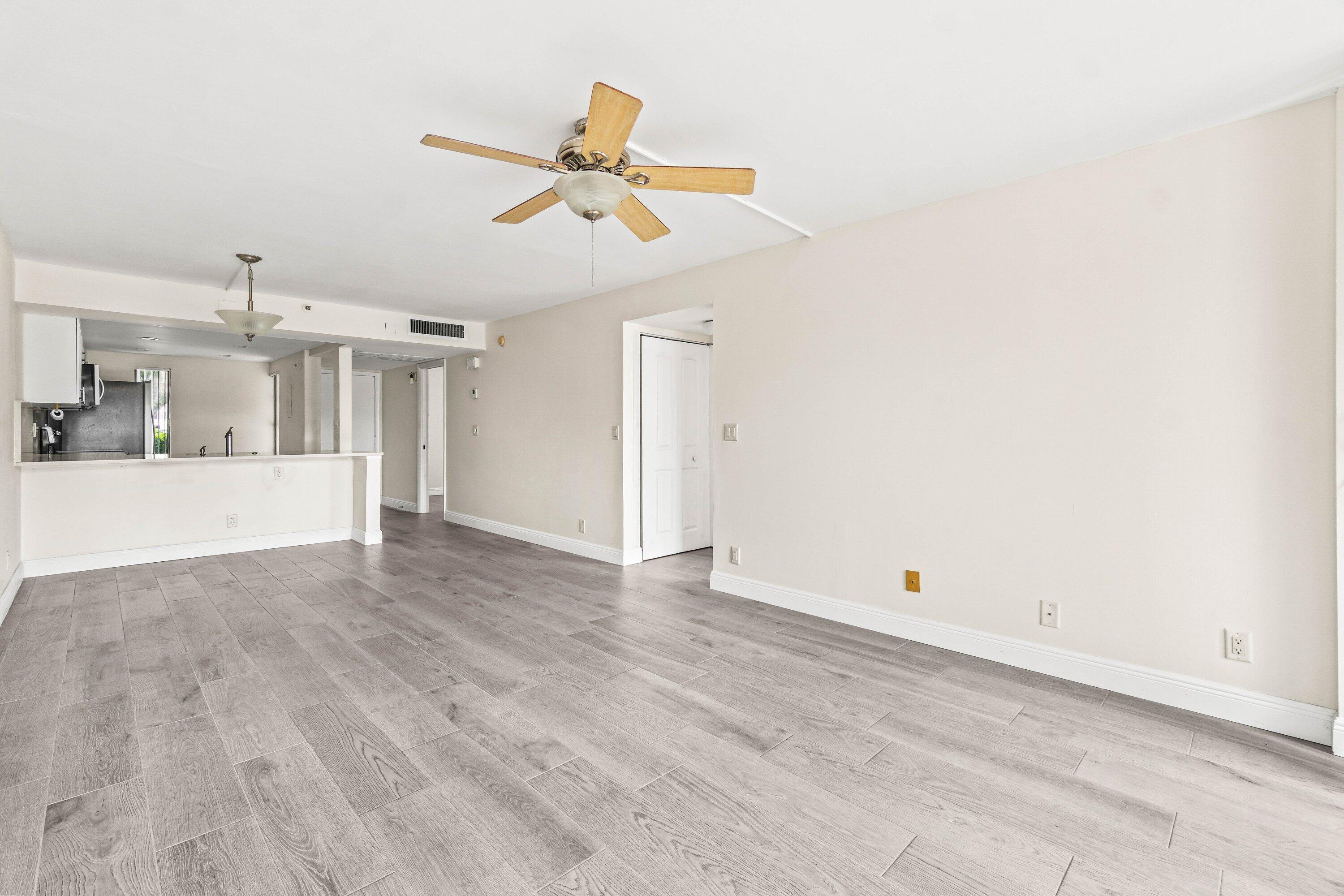 17 Royal Palm Way, Unit 103 Boca Raton, FL 33432 - Photo 15 of 28 an empty room with wooden floor ceiling fan and window