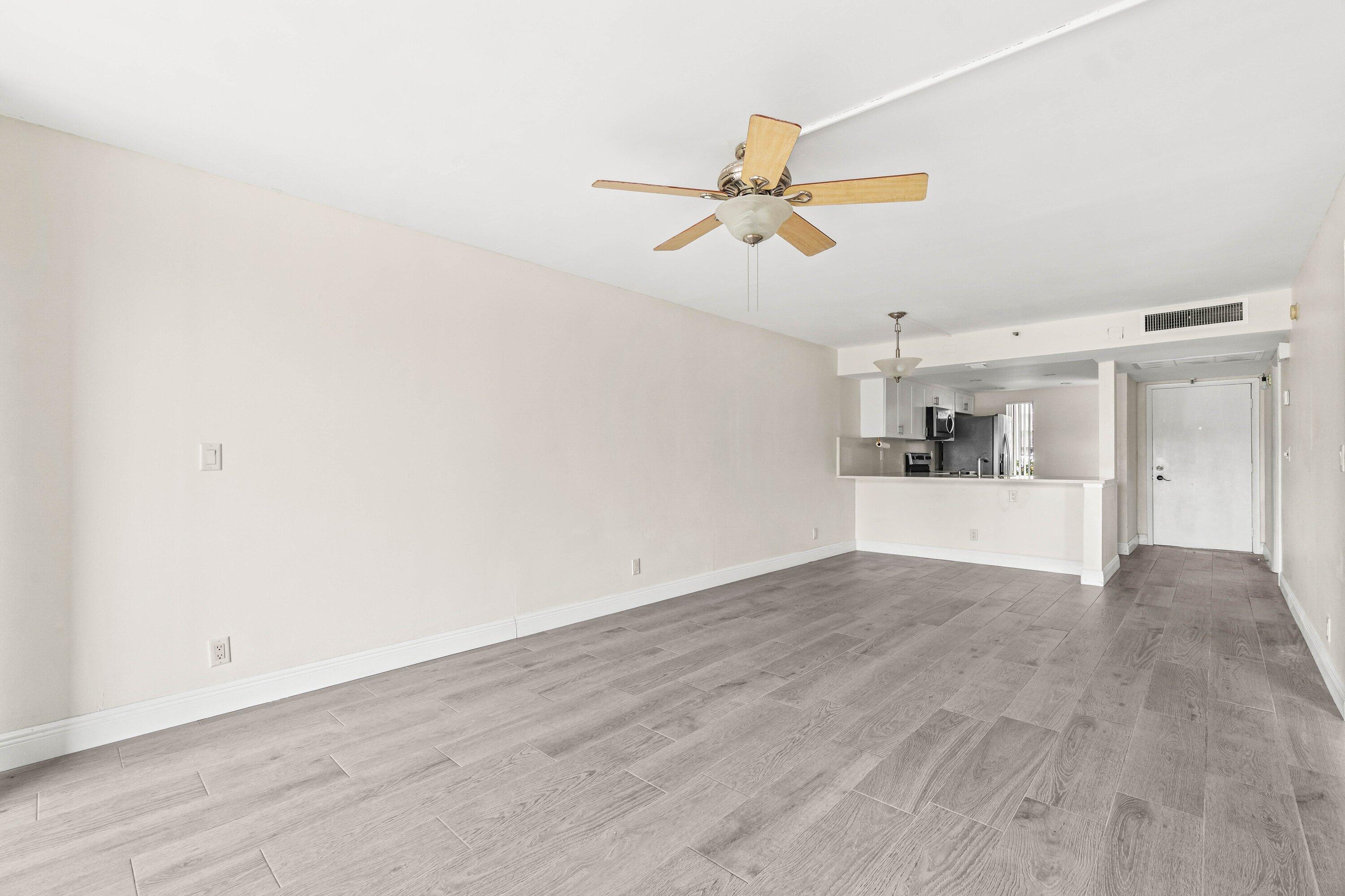 17 Royal Palm Way, Unit 103 Boca Raton, FL 33432 - Photo 16 of 28 a view of empty room with wooden floor and ceiling fan