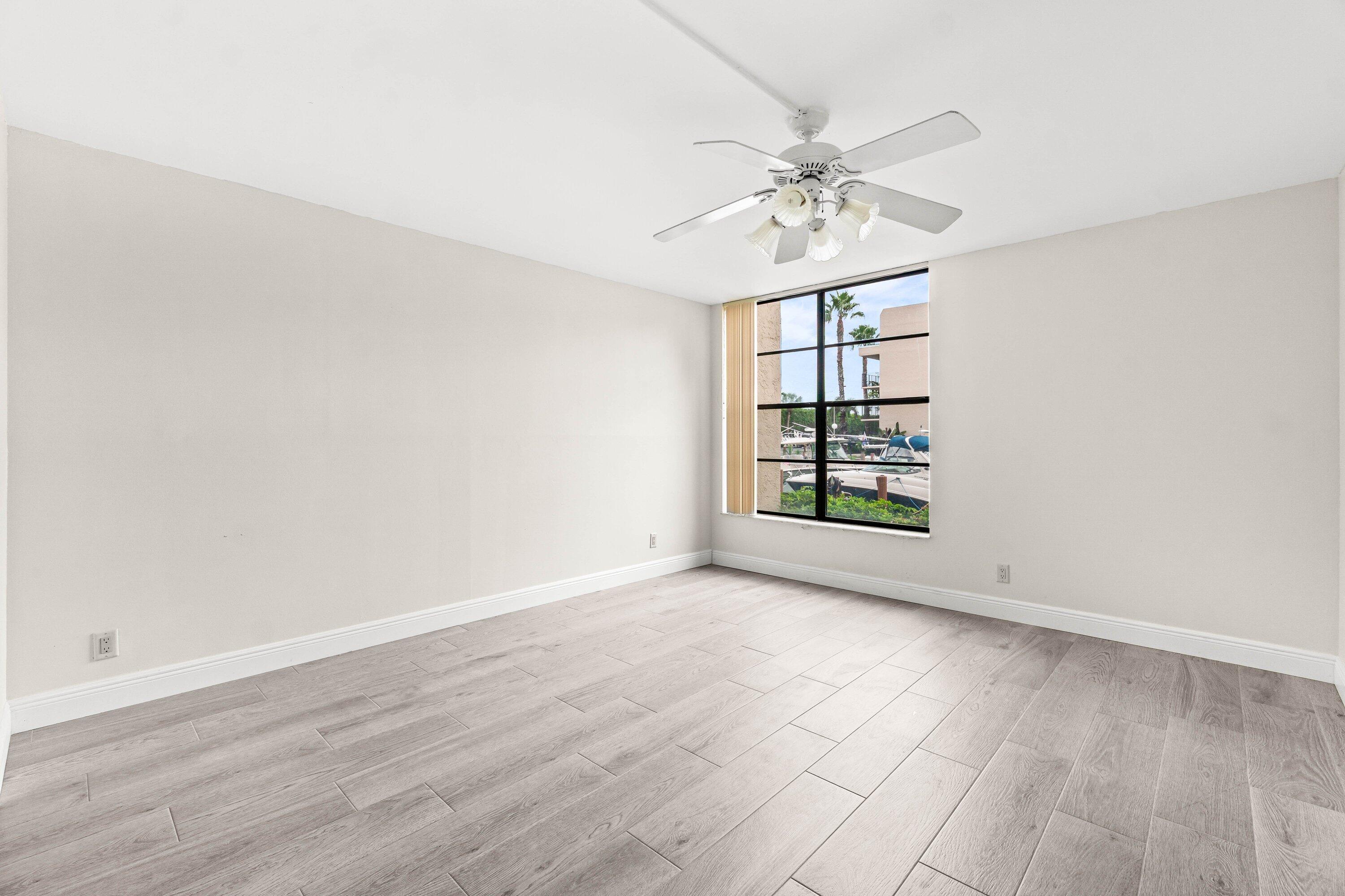 17 Royal Palm Way, Unit 103 Boca Raton, FL 33432 - Photo 18 of 28 wooden floor in an empty room with a window