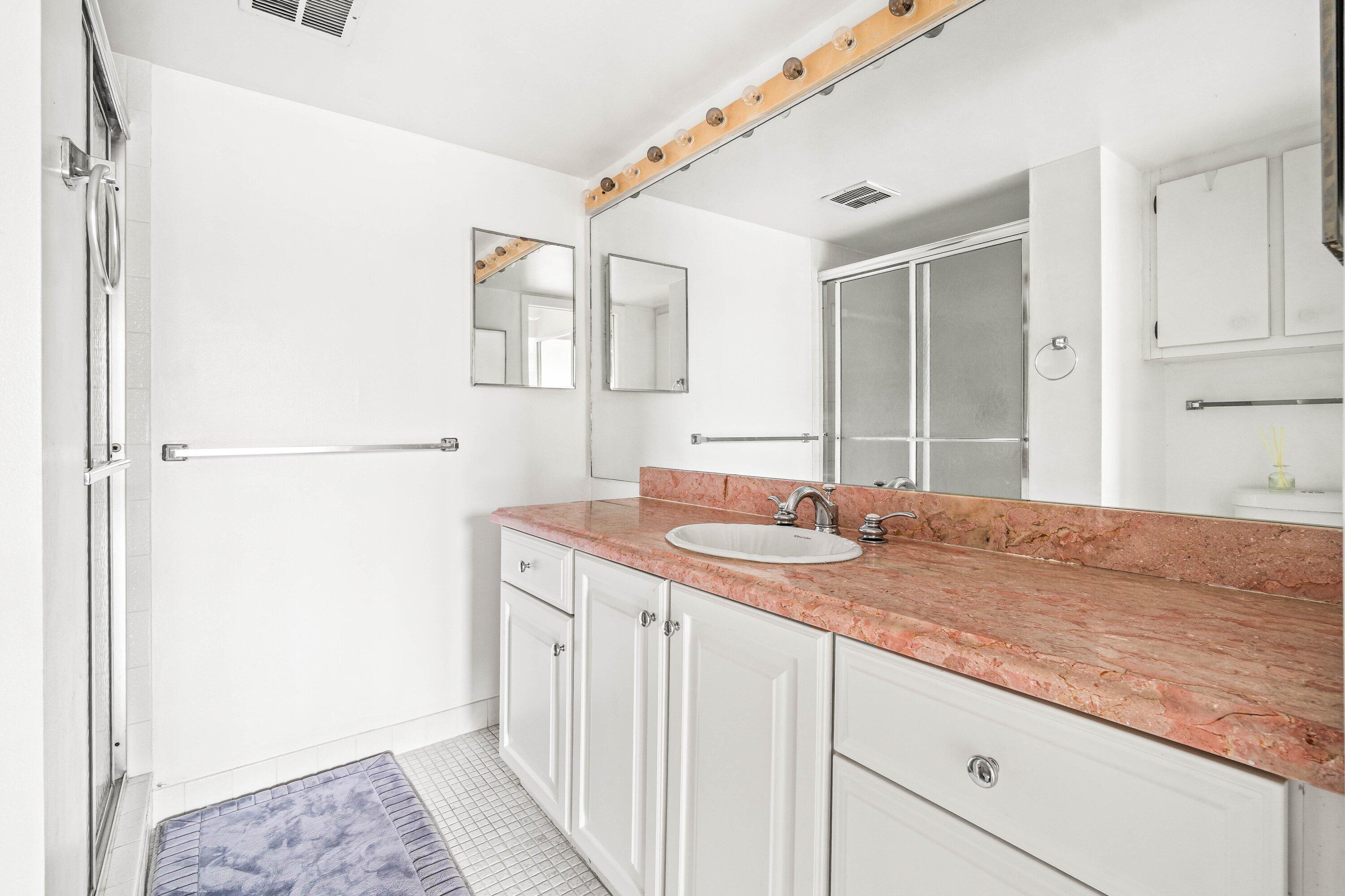 17 Royal Palm Way, Unit 103 Boca Raton, FL 33432 - Photo 20 of 28 a bathroom with a sink and a mirror