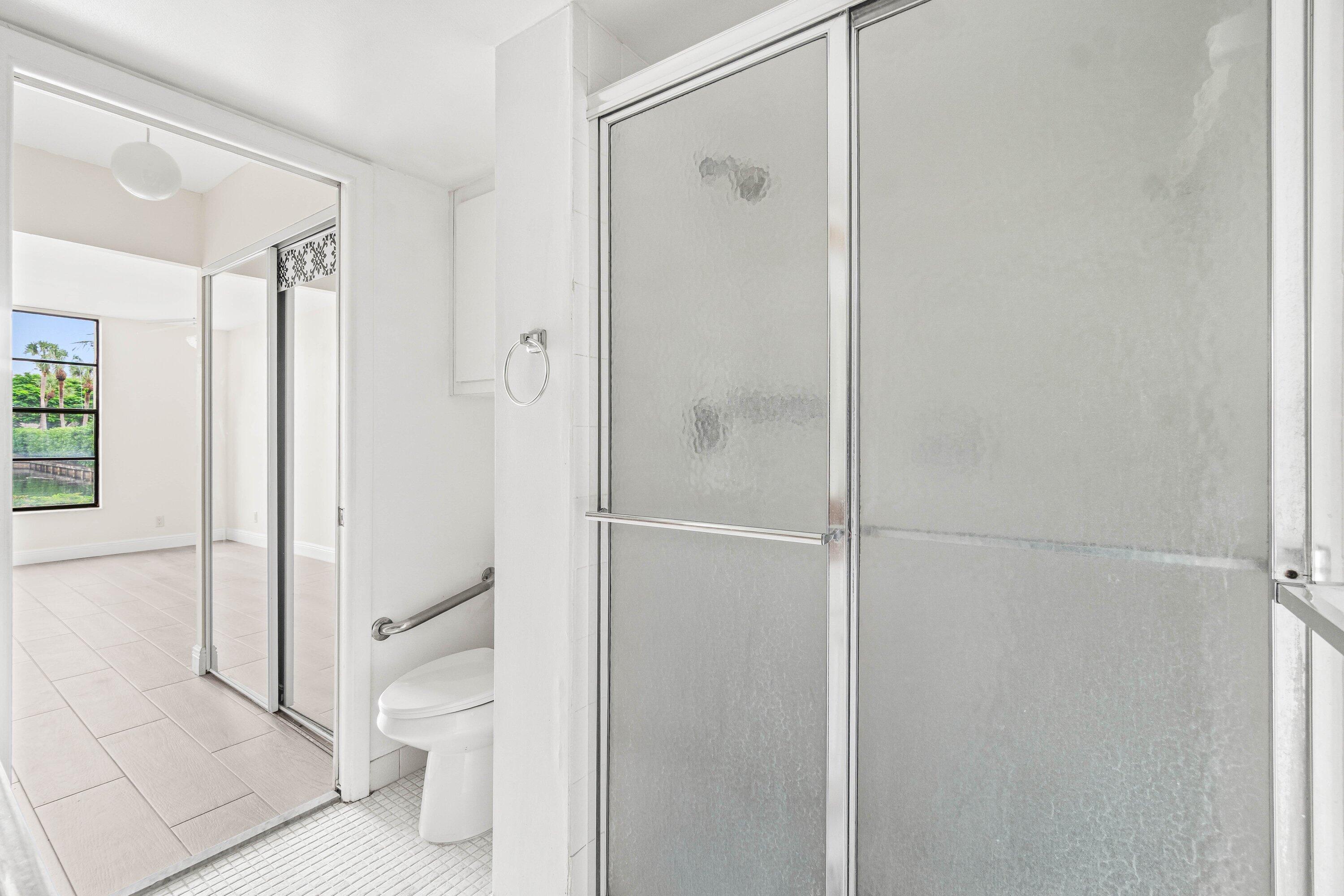 17 Royal Palm Way, Unit 103 Boca Raton, FL 33432 - Photo 21 of 28 a bathroom with a shower and a toilet