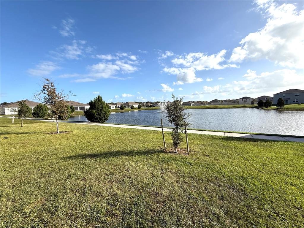 2877 Sunridge Loop St. Cloud, FL 34771 - Photo 18 of 19 a view of a lake with outdoor space