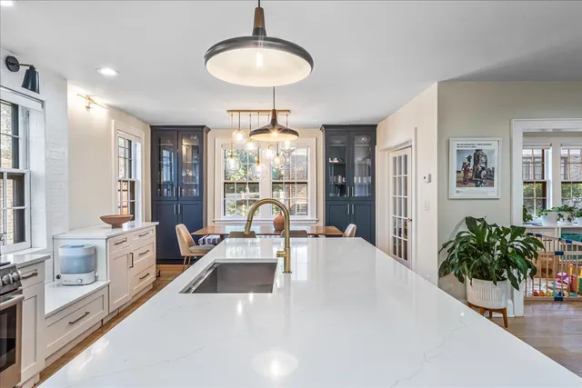 a view of a dining room with furniture large windows and wooden floor