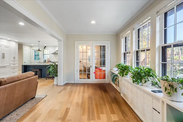a large white kitchen with a large window and stainless steel appliances