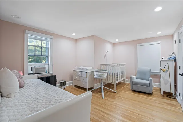 a bedroom with a bed and a flat screen television