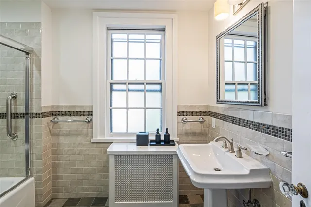 a bedroom with a bed and a walk in closet with wooden floor