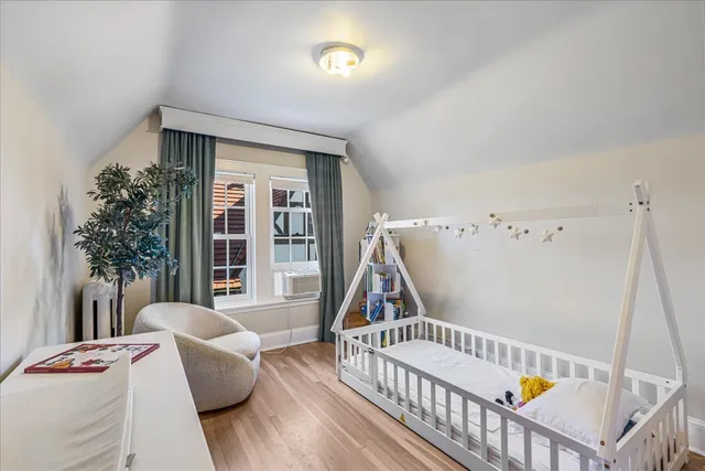 a bedroom with a bed and a plant in it