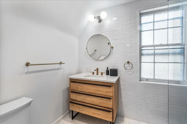 a living room with hard wood flooring and a book shelf