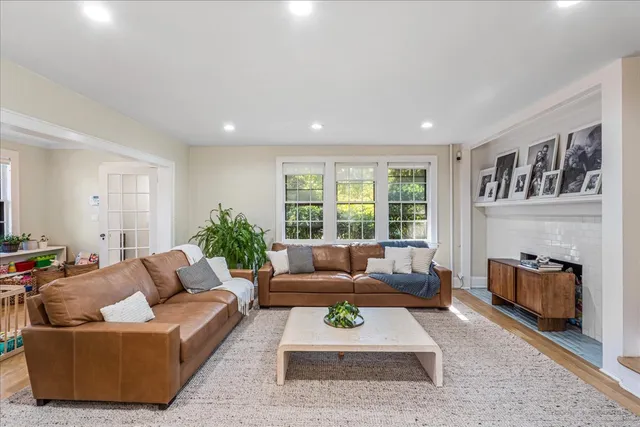 a living room with furniture and a fireplace