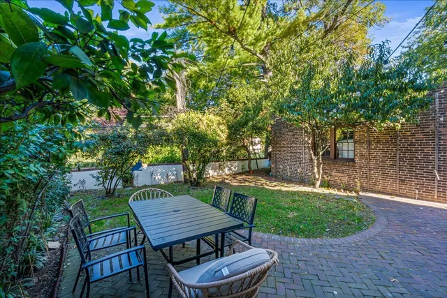 a view of a backyard with sitting area