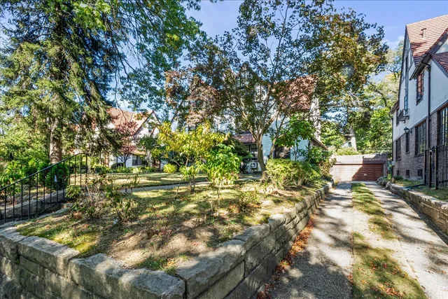 a backyard of a house with a table and chairs