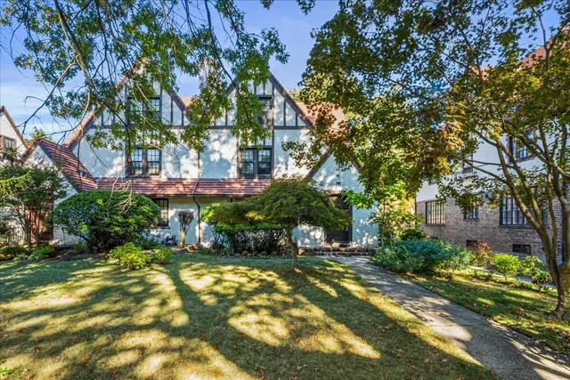 a view of yard with green space and bench