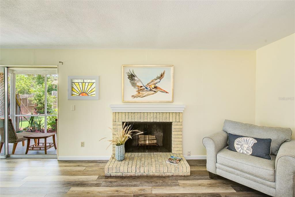 14079 Victoria Road Largo, FL 33774 - Photo 15 of 46 a living room with furniture and a fireplace
