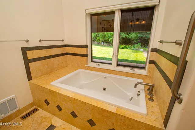 a bath tub sitting next to a window