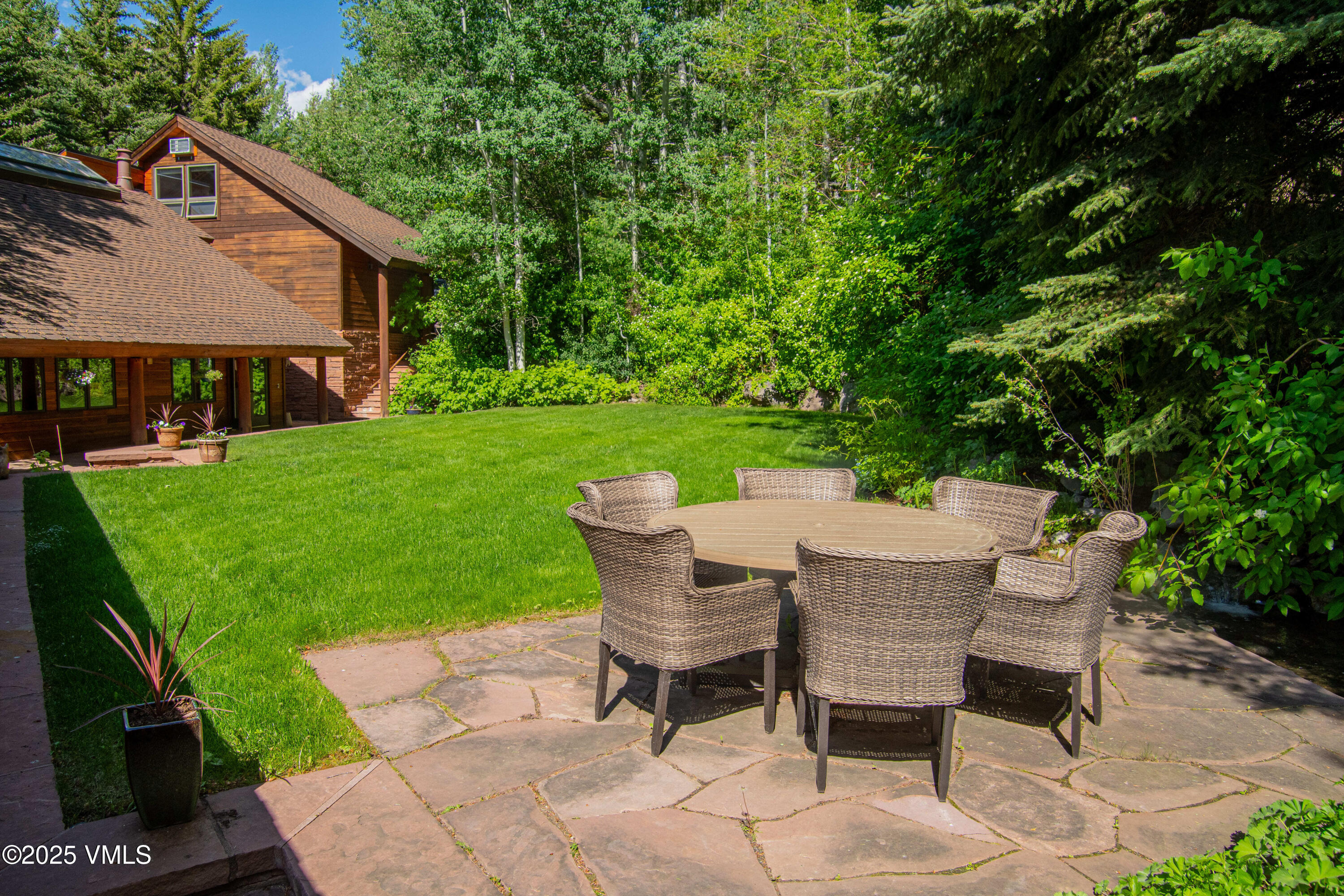 1461 Greenhill Court, Unit A AND B Vail, CO 81657 - Photo 25 of 44 a view of a table and chairs in backyard of the house