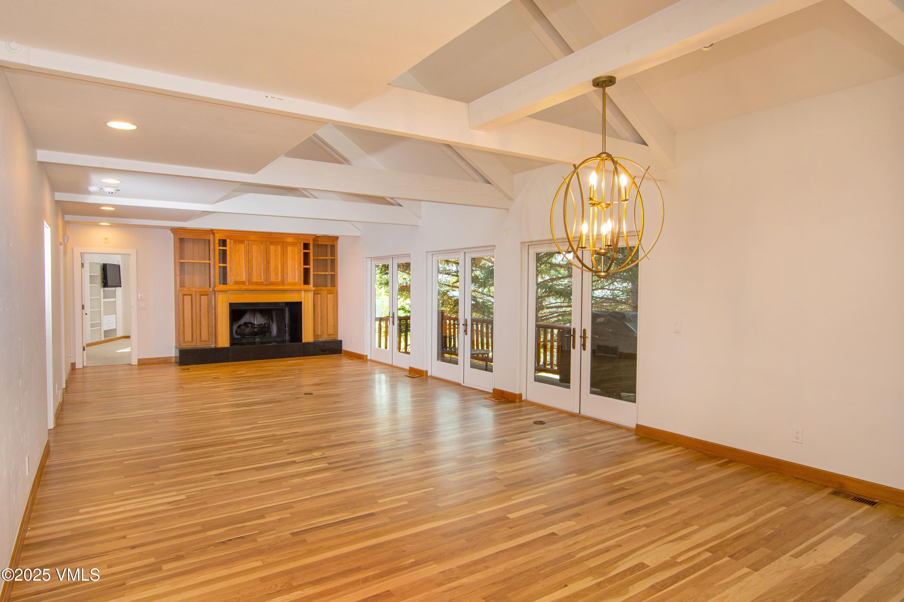 1461 Greenhill Court, Unit A AND B Vail, CO 81657 - Photo 4 of 44 a view of empty room with wooden floor and fireplace