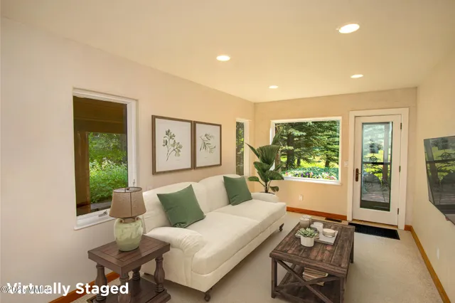 a living room with furniture and a large window