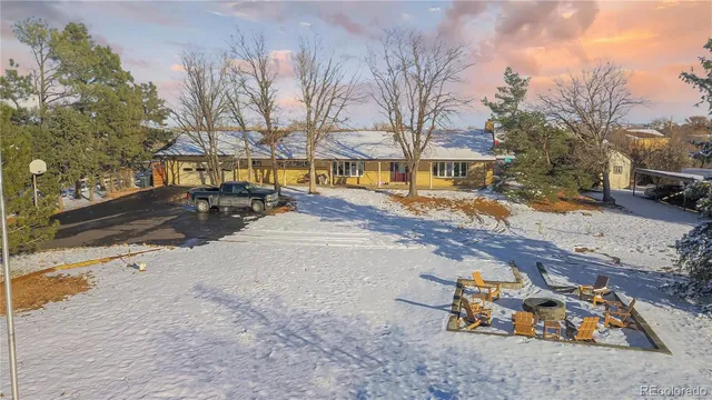 a view of a yard with snow on the road