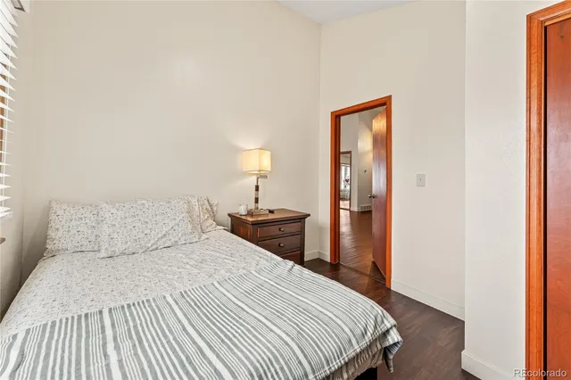 a bedroom with a bed and a lamp