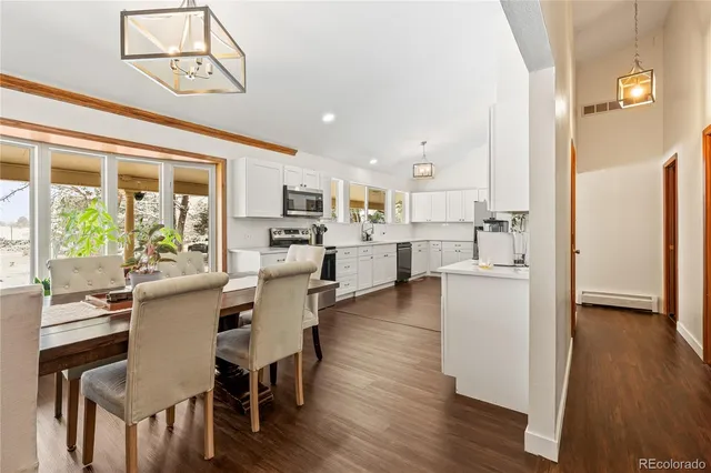 a dining room with furniture and wooden floor