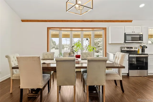 a view of a dining room with furniture window and wooden floor
