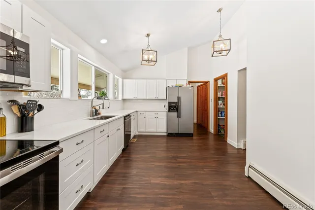 a kitchen with stainless steel appliances a refrigerator sink and cabinets