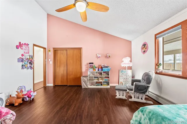 a bathroom with a toilet sink vanity granite and shower