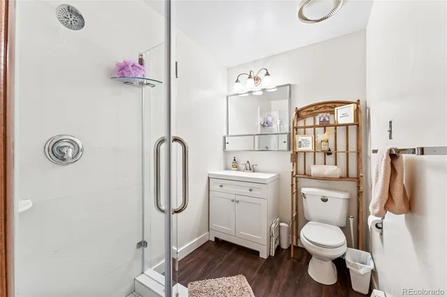 a bedroom with furniture and wooden floor