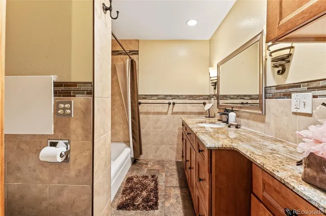 a bathroom with a tub a sink and a glass door shower