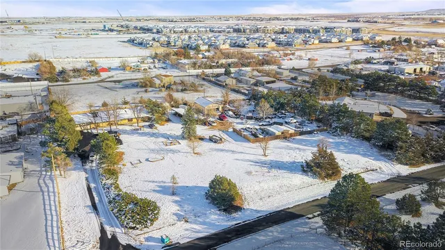 a view of a yard with snow on the road