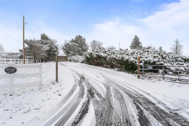 a view of a house with a yard covered in snow