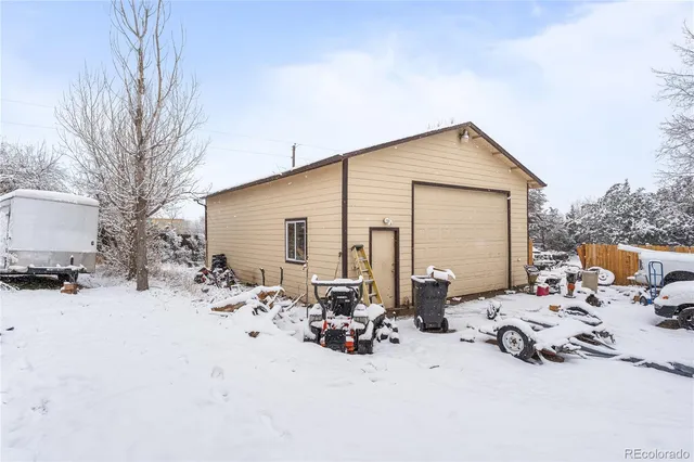 a view of a house with a snow in the yard
