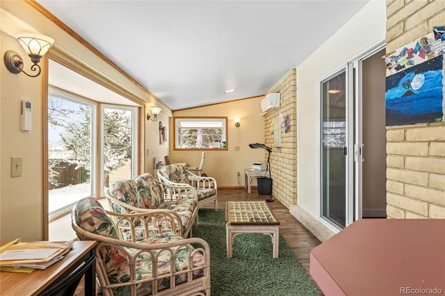 a living room with furniture and a floor to ceiling window